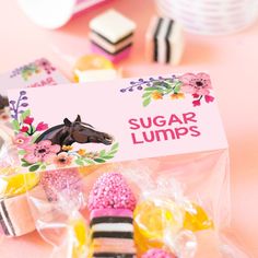 a bag of sugar lumps sitting on top of a table next to other candies