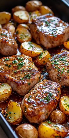 some meat and potatoes in a pan with seasoning on top for garnish