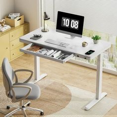 a computer desk with a clock on the screen and a chair in front of it