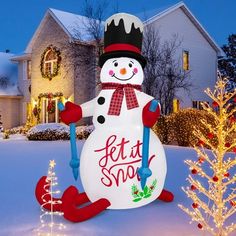 a snowman in front of a house decorated with christmas lights and decorations for the holiday season