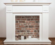 a brick fireplace with white paint and decorations