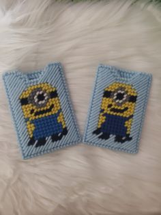 two minion patches sitting on top of a white furnishing floor next to each other