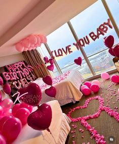 balloons and streamers fill the floor in this bedroom decorated for a baby's first birthday