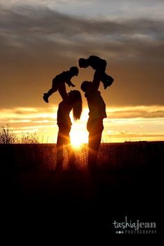 the silhouettes of two people and a child are shown at sunset