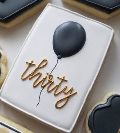 cookies decorated with black and white icing that say party on top of the cookie