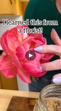 a woman holding a pink flower in her hand with the caption i learned this from a florist