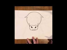 someone is drawing a cow's head on paper