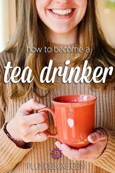 a woman holding a red coffee mug with the words how to become a tea drinker