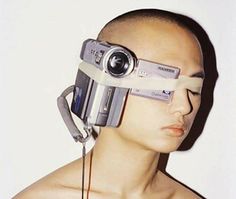 a man with a camera attached to his head and an eyepiece in front of him