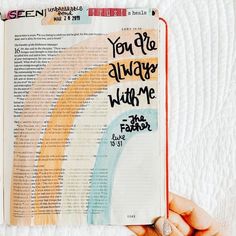 an open bible with the words you're always with me and rainbow painted on it