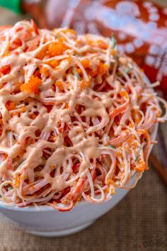 a white bowl filled with coleslaw on top of a table