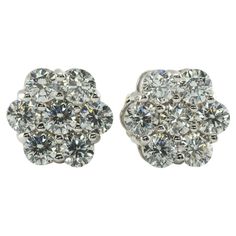 Diamond Earrings Studs 14K White Gold Cluster 1.12 TDW This pair of diamond cluster studs is crafted in solid 14K White Gold. There are seven natural round brilliant cut diamonds totaling 1.12 carats for the pair. The diamonds are VS2-SI1 clarity and HI color. The earrings are equipped with long posts and butterfly backings. The top of the earrings measures 9mm. The earrings weigh 2.7 grams. Great estate condition. White Gold Studs, Diamond Cluster, Round Brilliant Cut Diamond, Diamond Earrings Studs, Estate Jewelry, Jewelry Earrings Studs, Diamond White, Diamond Jewelry, Diamond Earrings