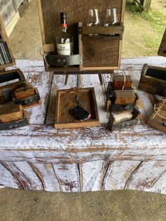 several wooden boxes and wine glasses on a table