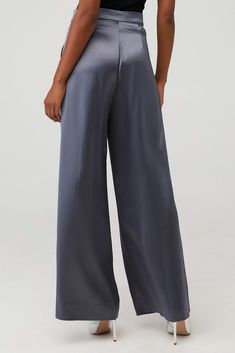 NonChalan'ts Paris Pant is a high-waisted, wide-leg pant made from 100% polyester. Simple, yet elegant the silky look elevates the overall appearance of the pant. The small touches such as pleats and the front zipper closure make them all the more unique. 100% Triacetate. Traci is 5'3", wearing size XS. Dry Clean Only. 2024 Style, Tailored Pants, Silk Material, Grey Pants, Online Boutiques, Instagram Followers, Front Zipper, Wide Leg Pants, Gray Color