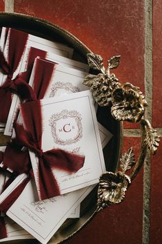 red and white wedding stationery in a metal bowl