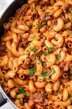 a pot filled with pasta and meat sauce