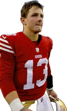 a close up of a football player holding a ball and a helmet in his hands