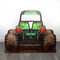 the monster truck is painted green and red