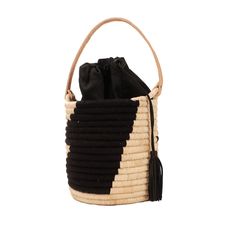 The Coba Basket Bag is the perfect carry-all for your personal items or toting a favorite bottle of rose' to the beach. The tote has a natural leather handle, a black cotton drawstring lining to secure your belongings and is finished off with a black leather tassel. It's natural style all the way from city to beach. Made from raffia, nylon and cow leather Measures: 7"H 6"W (not including handle) Black Bucket Bag For Beach, Chic Black Straw Bag, Black Top Handle Beach Shoulder Bag, Black Top Handle Beach Bag, Black Travel Shoulder Bag With Bamboo Handle, Casual Black Top Handle Beach Bag, Beach Bucket Bag With Top Handle And Removable Pouch, Beach Bucket Bag With Removable Pouch And Top Handle, Black Bucket Shaped Bag For Summer