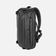 the back view of a black backpack on a white background with no one in it