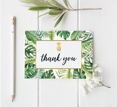 thank you card with tropical leaves and pineapple on white wooden background next to pencil