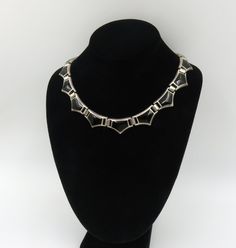 Originally $475.00.  Vintage Mexican Necklace with Black Onyx inlayed in Sterling Silver.  This necklace is a dream to wear and is of excellent craftsmanship: The hinged design allows this necklace to lay beautifully just like a collar that fits well around the neck.   The inner circumference is 16 3/4 inches It is stamped "Mexico"  and 925 The condition is excellent with minimal wear. Formal Art Deco Necklace With Polished Finish, Art Deco Hallmarked Necklaces For Evening Wear, Formal Onyx Necklace With Black Enamel, Formal Onyx Necklace With Polished Finish, Art Deco Hallmarked Necklace For Evening, Black Metal Necklace With Polished Finish, Vintage Black Hallmarked Necklace, Vintage Black Necklaces For Evening, Vintage Black Necklace For Evening