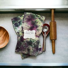 kitchen utensils and wooden spoons are on the counter next to each other