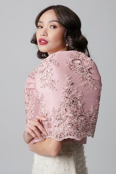 The Ivy Bolero by The Mestizo reimagines the classic Filipiniana silhouette with a touch of couture. Crafted from luxurious old rose peau de soie, this exquisite piece features intricately detailed corded lace butterfly sleeves that steal the show. The lace adds a unique visual interest and a touch of romantic charm, making it perfect for both formal and casual occasions. Pair it with a flowing gown for a grand entrance or elevate your favorite summer dress for a sophisticated yet breezy look. B Modern Filipiniana Gown Wedding, Classic Filipiniana, Bolero Filipiniana, Filipiniana Gown, Modern Filipiniana Gown, Old Rose Color, Modern Filipiniana Dress, Flowing Gown, Philippines Fashion