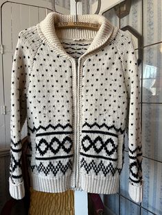 This great sweater from Levi's is made from 80 per cent wool and 20 per cent polyamide in ivory/off white/light beige with black accents. It has a shawl collar, a full zipper in the front and two front pockets. Marked size small. The measurements, taken with the sweater lying flat, are: shoulder to shoulder, 16 inches; armpit to armpit, 18 inches; sleeves, 23 inches; length, 24 inches; bottom edge, 16 inches (with stretchy ribbing). The sweater has some pilling, but overall it's in very good vintage condition. Black And Beige, Black Accents, Sweater Black, Wool Cardigan, White Beige, Shawl Collar, Vintage Levis, Wool Sweater, Black Print