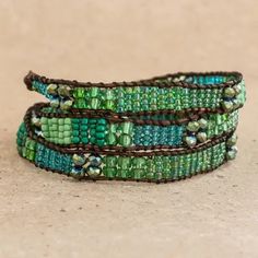 three green and brown beaded bracelets sitting on top of each other