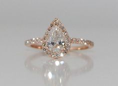 an engagement ring with a pear shaped diamond