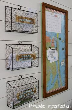 three wire baskets are hanging on the side of a wall with magnets attached to them