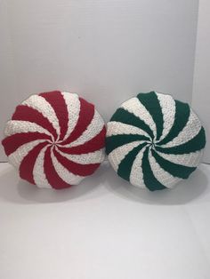 two knitted pepperminks sitting on top of each other in front of a white wall