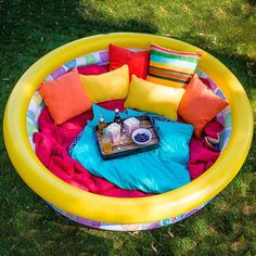 an inflatable pool with lots of pillows on it and some other things inside