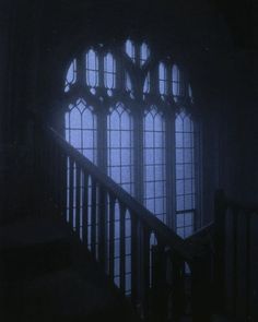 an image of stairs and windows in the dark