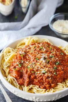 homemade spaghetti sauce in a white bowl with parmesan cheese