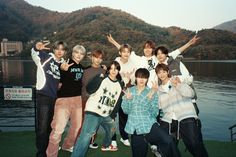 a group of young men standing next to each other on top of a grass covered field