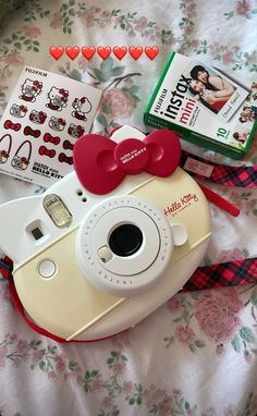 a camera and some stickers on a bed