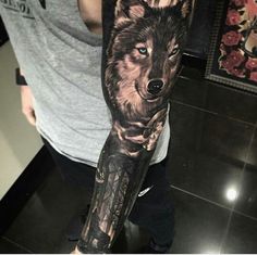 a man with a wolf tattoo on his arm