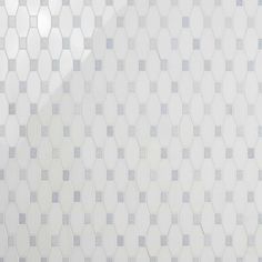 a white tiled wall with hexagonal shapes