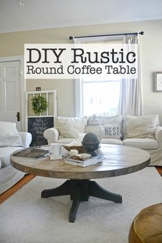 a living room with white couches and a round coffee table in front of a window