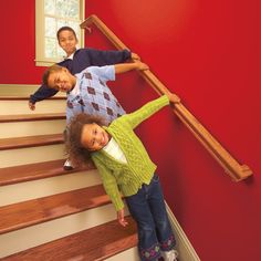 three children are standing on the stairs with their arms around each other