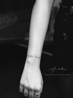 a woman's arm with a small tattoo on it, and the word love is written