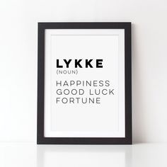 a black and white framed poster with the words lykke in different languages on it