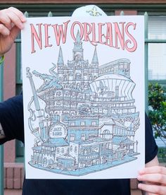 a person holding up a poster with the words new orleans on it in front of a building