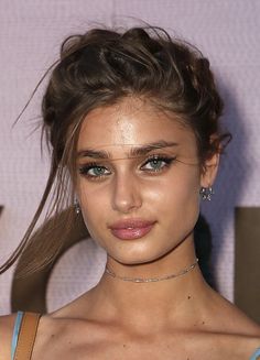 a close up of a person wearing a choker and dress with hair in the wind