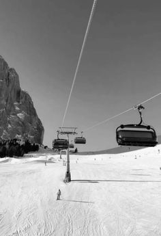 the ski lift is going down the snowy mountain