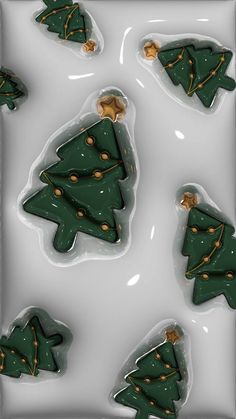 christmas tree shaped cookies are on a white tray