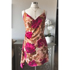 Step Into Elegance With Our Women's Floral Ruched Side Dress, A Perfect Blend Of Femininity, Romance, And Sophistication. This Stunning Dress Features A Flattering Ruched Side Design That Hugs Your Curves In All The Right Places, Creating A Silhouette That's Both Elegant And Alluring. The Dress Showcases A Beautiful Floral Print In Rich Hues Of Pink And Brown, Making It A Standout Piece For Any Special Occasion. The Adjustable Straps And Back Zipper Closure With A Hook And Eye Ensure A Perfect F Satin V-neck Dress For Garden Party, Satin Floral Print Dress For Night Out, Satin Floral Print Mini Dress For Brunch, Floral Print Satin Mini Dress For Brunch, Floral Print Satin Mini Dress, Fitted Satin Dress With Floral Print, Summer Floral Print Satin Mini Dress, Feminine Floral Print Dress For Night Out, Satin Mini Dress For Garden Party