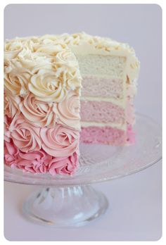 there is a cake with pink and white frosting on it